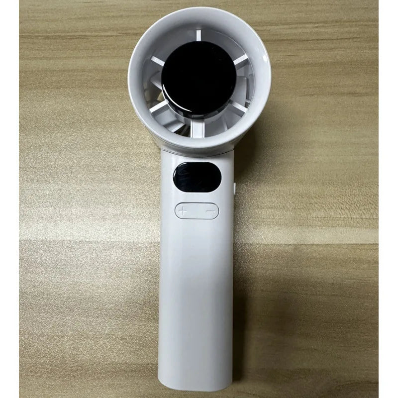 Compact handheld ice fan held in hand outdoors